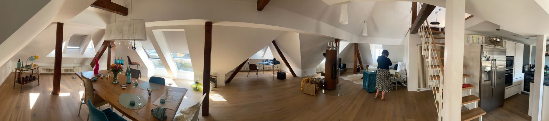 panoramic photo of a loft apartment with wooden beams