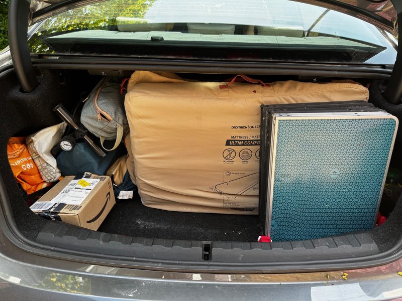 car boot almost fully packed with camping gear