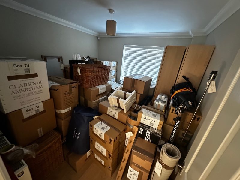 A room filled with boxes stacked high and all with labels